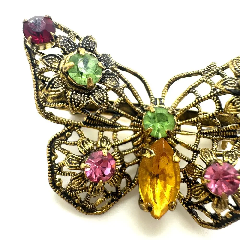 Vintage gold tone filigree multicolor prong set rhinestones butterfly brooch